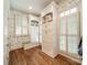 Mudroom features custom cabinets and storage with warm hardwood flooring and shuttered windows for ample light at 4001 Doves Roost Ct, Charlotte, NC 28211