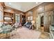 Handsome wood-paneled office featuring built-in bookshelves and a cozy sitting area at 4001 Doves Roost Ct, Charlotte, NC 28211