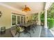 Covered patio featuring an outdoor kitchen, fan, and elegant dining set perfect for entertaining guests at 4001 Doves Roost Ct, Charlotte, NC 28211