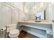 Elegant powder room with unique vanity, decorative wallpaper, and stylish lighting fixture at 4001 Doves Roost Ct, Charlotte, NC 28211