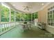 Charming screened porch with a dining table and view of the pool, ideal for relaxation at 4001 Doves Roost Ct, Charlotte, NC 28211