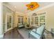 Bright and airy sunroom furnished with comfortable seating and multiple doors leading to the outside at 4001 Doves Roost Ct, Charlotte, NC 28211