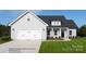 Charming one-story home featuring a two-car garage, covered front porch, and well-manicured lawn at 4018 Deerstone Ln # 24, Clover, SC 29710