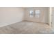 Bright bedroom with two windows and neutral carpet at 422 Nixon Rd, Belmont, NC 28012