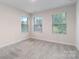 Bedroom with three windows, neutral paint, and carpet at 422 Nixon Rd, Belmont, NC 28012