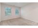 Bedroom with two windows, neutral paint, and carpet at 422 Nixon Rd, Belmont, NC 28012