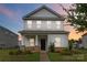 Charming two-story home featuring a covered porch with stone accents and well-manicured landscaping at 422 Nixon Rd, Belmont, NC 28012