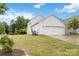 Exterior angle of home showcasing the garage door and side yard with green grass at 422 Nixon Rd, Belmont, NC 28012
