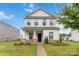 Charming two-story home featuring a covered porch with stone accents and well-manicured landscaping at 422 Nixon Rd, Belmont, NC 28012