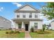 Charming two-story home featuring a covered porch with stone accents and well-manicured landscaping at 422 Nixon Rd, Belmont, NC 28012