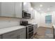 Modern kitchen featuring stainless steel oven and range, and gray cabinetry at 422 Nixon Rd, Belmont, NC 28012