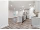 Modern kitchen with island, stainless appliances, and luxury vinyl plank flooring at 422 Nixon Rd, Belmont, NC 28012