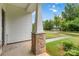 Covered porch featuring stone column bases and views of the green lawn at 422 Nixon Rd, Belmont, NC 28012