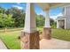 Covered porch featuring stone column bases and views of the green lawn at 422 Nixon Rd, Belmont, NC 28012