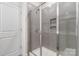 Gray tiled shower with glass door at 422 Nixon Rd, Belmont, NC 28012