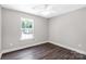 Bright bedroom with a window letting in natural light, complemented by dark wood flooring at 506 Locust St, Rock Hill, SC 29730