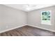 Bright bedroom with a modern ceiling fan and a window letting in natural light, complemented by dark wood flooring at 506 Locust St, Rock Hill, SC 29730