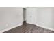 The bedroom has dark floors, white trim and an open doorway to another bedroom, and a closet at 506 Locust St, Rock Hill, SC 29730