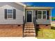 Charming home with gray siding and brick foundation, featuring a welcoming front entrance at 506 Locust St, Rock Hill, SC 29730
