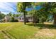 Charming home with gray siding and brick foundation, surrounded by a lush green lawn at 506 Locust St, Rock Hill, SC 29730