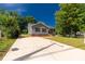 Charming home with gray siding and brick foundation, featuring a spacious concrete driveway at 506 Locust St, Rock Hill, SC 29730