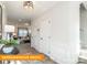 Bright entryway with decorative wainscoting, view to a living room, and a staircase leading upstairs at 530 Hullview Vis, Monroe, NC 28110