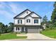 Charming two-story home featuring white siding, a stone foundation, and a two-car garage for modern Gathering living at 530 Hullview Vis, Monroe, NC 28110