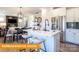Stylish kitchen featuring white cabinetry, stainless steel appliances, granite countertops, and an island with barstools at 530 Hullview Vis, Monroe, NC 28110