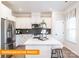Modern kitchen featuring white cabinets, stainless steel appliances, and a center island with breakfast bar seating at 530 Hullview Vis, Monroe, NC 28110