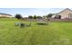 Spacious backyard featuring a trampoline, playground, and outdoor seating area at 5668 Stanfield Ridge Dr, Stanfield, NC 28163