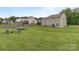 Expansive backyard features a wooden fence, trampoline and outdoor seating, perfect for entertaining at 5668 Stanfield Ridge Dr, Stanfield, NC 28163
