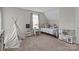 Neutrally decorated bedroom with teepee tent, play kitchen, and carpet flooring at 5668 Stanfield Ridge Dr, Stanfield, NC 28163