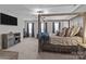 Bedroom features a statement four-poster bed, a TV, and windows overlooking the yard at 5668 Stanfield Ridge Dr, Stanfield, NC 28163