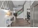 Inviting entryway with gray accent wall, wood floors, and staircase leading to the upper level at 5668 Stanfield Ridge Dr, Stanfield, NC 28163