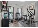 A compact home gym includes treadmill, weight rack, elliptical, and mounted TV at 5668 Stanfield Ridge Dr, Stanfield, NC 28163