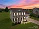 Stunning two-story home with a landscaped front yard and a cozy porch perfect for relaxing evenings at 5668 Stanfield Ridge Dr, Stanfield, NC 28163