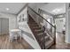View of an entry and stairway highlighting natural light, modern decor, and hardwood flooring at 5668 Stanfield Ridge Dr, Stanfield, NC 28163