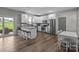 A large kitchen with stainless steel appliances, an island with stools, and lots of counter space at 5668 Stanfield Ridge Dr, Stanfield, NC 28163