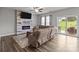 Open concept living area features a fireplace, a large sectional, and sliding glass doors to the backyard at 5668 Stanfield Ridge Dr, Stanfield, NC 28163