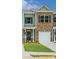 Charming townhome featuring a mix of brick and siding, an attached garage, and a neatly manicured lawn at 6013 Jasmine Branch Rd, Charlotte, NC 28216