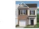 New two-story townhouse with a brick facade, white trim, and a front-entry garage at 6013 Jasmine Branch Rd, Charlotte, NC 28216