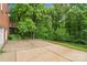 Large concrete patio, mature trees, and backyard area at 626 Trail Ridge Rd, Matthews, NC 28105