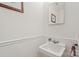 Stylish powder room featuring a modern sink, framed mirror, and patterned wallpaper at 626 Trail Ridge Rd, Matthews, NC 28105