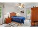 Cozy bedroom with a comfortable bed, nightstands, and a ceiling fan at 626 Trail Ridge Rd, Matthews, NC 28105