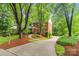 Beautiful brick home with lush landscaping, a curved driveway, and a well-maintained lawn, enhancing its curb appeal at 626 Trail Ridge Rd, Matthews, NC 28105