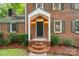 Inviting front porch with brick steps and a covered entrance, complemented by green shutters and lush landscaping at 626 Trail Ridge Rd, Matthews, NC 28105