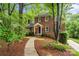 Charming brick home featuring a manicured front yard with mature trees and a walkway to the entrance at 626 Trail Ridge Rd, Matthews, NC 28105