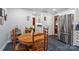 Cozy kitchen featuring a round wooden table, stainless steel refrigerator, and classic white cabinetry at 626 Trail Ridge Rd, Matthews, NC 28105