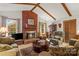 Inviting living room featuring a brick fireplace, wood beams, and comfortable seating at 626 Trail Ridge Rd, Matthews, NC 28105