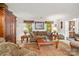Comfortable living room with a sofa, a coffee table, and two windows with decorative curtains at 626 Trail Ridge Rd, Matthews, NC 28105